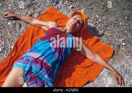 Mature nude woman at the beach Stock Photo - Alamy