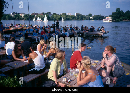 Tourists relaxing at coast on footbridge Alster Lake Hamburg Germany Stock Photo