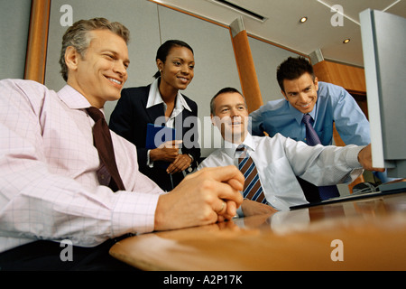 Businesspeople looking at computer monitor Stock Photo
