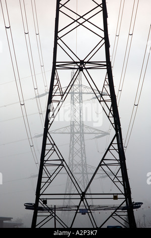 Electricity pylons in fog in Redditch Worcestershire UK Stock Photo