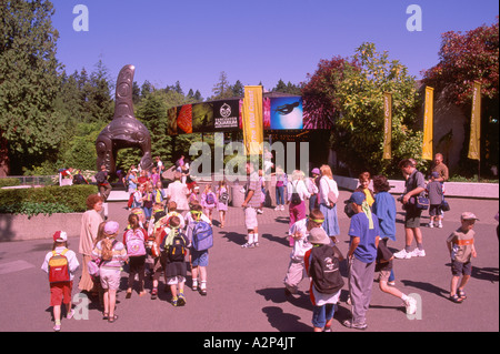 Schoolchildren visiting Haida Killer Whale Sculpture and Vancouver Aquarium in Stanley Park Vancouver British Columbia Canada Stock Photo