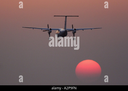 passenger airplane landing at sunset, Germany, Bavaria Stock Photo
