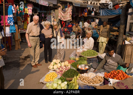 India Old Delhi Paharganj Bazaar older western tourists in vegetable market Stock Photo