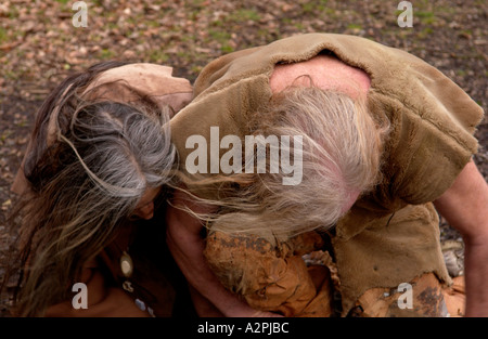 Professional stoneage reenactors trying to make fire at The Museum of Welsh Life St Fagans Cardiff Wales UK Stock Photo