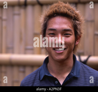 Young Japanese man with dyed hair visiting Kinkakuji temple Stock Photo