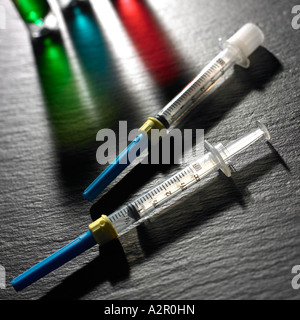 Syringe with Coloured Glasware Stock Photo