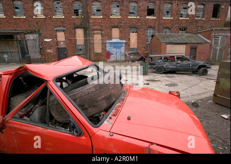 abandoned cars in a run down area of Barrow in Furness Cumbria