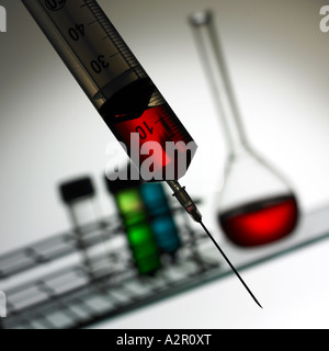 Syringe with Shelf in Background with Glassware Stock Photo