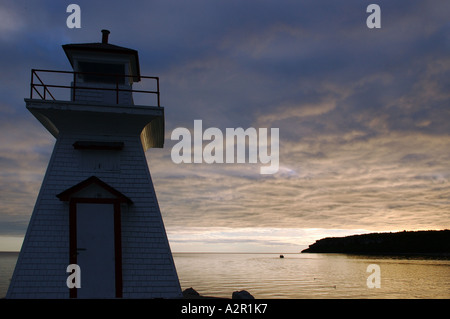 Lighthouse with fishing boat at dawn  at Lions Head on lake Huron Georgian Bay Bruce Peninsula Ontario Stock Photo