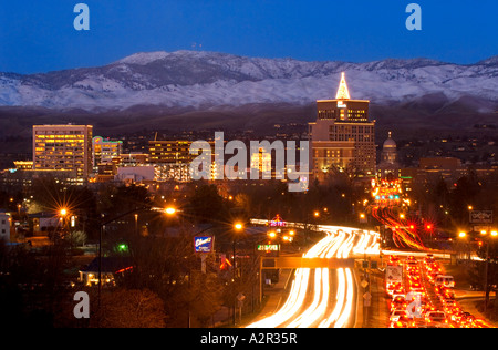 Idaho Boise Downtown skyline and the Boise Foothills with snow at twilight with traffic blur in winter Stock Photo