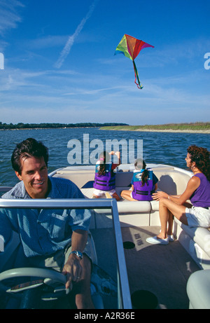 Family flying kite from boat near Hilton Head Island SC Stock Photo