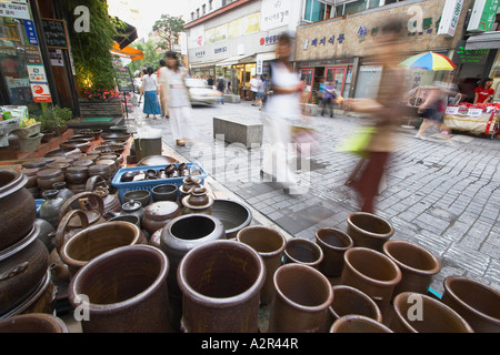 Pedestrians Walking Past Pottery Shop, Seoul Stock Photo