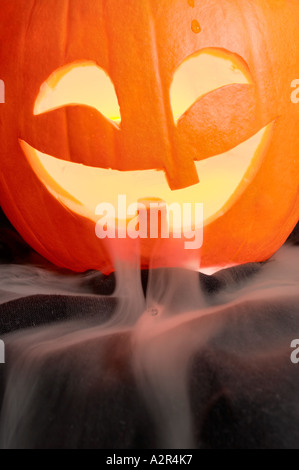Lit carved pumpkin with mist pouring out - Jack o lantern