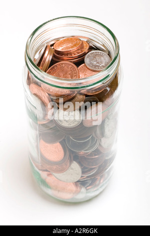 Glass jam jar filled with loose change Stock Photo