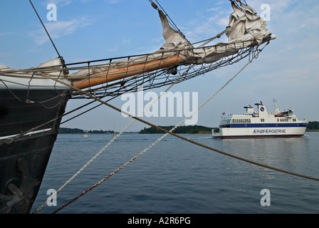 Old Sailing Ships in harbour Svendborg while a small island ferry leave Svendborg fyn Funen Denmark Stock Photo