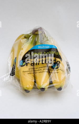 Bunch of wrapped fairtrade Waitrose bananas with FT logo from Dominican Republic UK Stock Photo