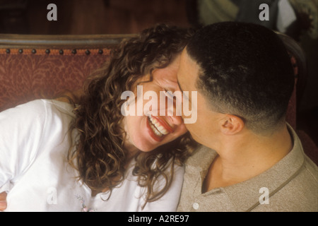 Hispanic man kissing mixed Hispanic woman Stock Photo