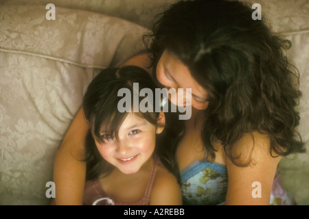 Mixed Asian Caucasian mother hugging 4 year old daughter Stock Photo