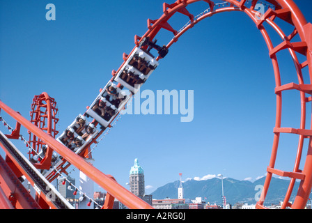 Roller Coaster / Rollercoaster called 'Scream Machine', People riding Amusement Park Thrill Ride Stock Photo