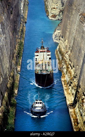 Tug leading container ship through Corinth Canal in Greece Stock Photo