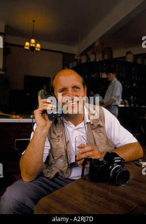 man with old mobile phone in a pub Stock Photo