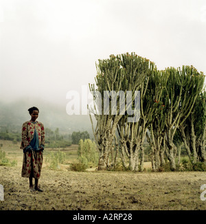 a young woman stands near a burial ground for the victims for the ethiopian famine of 1984 hayk north wollo ethiopia Stock Photo