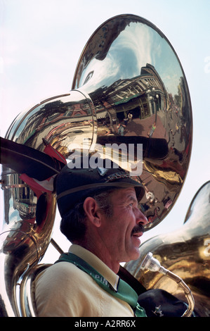 A Senior Man playing a Sousaphone or Tuba