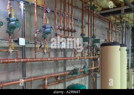 Metal Copper Water Pipes With Hot Water Heaters In Basement Stock Photo