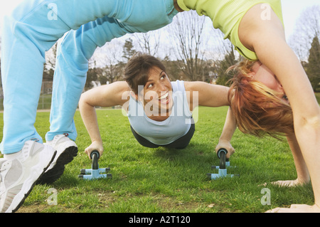 Two young women working out together Stock Photo