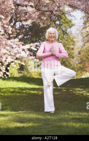 Older woman in a yoga position Stock Photo