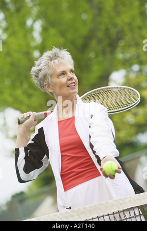 A middle aged woman playing tennis Stock Photo