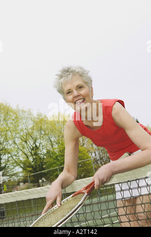 A middle aged woman playing tennis Stock Photo