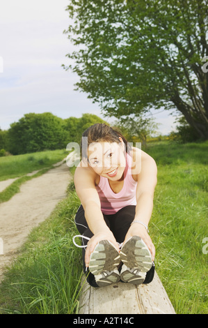 A young woman smiling and stretching Stock Photo