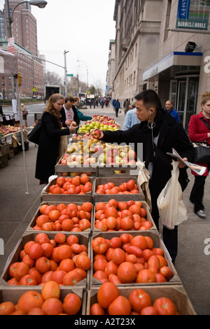 Street market stall selling tomatoes and fruit & vegetables. Broadway near Columbia University Upper West Side New York City USA Stock Photo