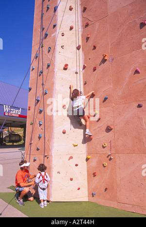 Climbing Wall, Whistler, BC, British Columbia, Canada - Children using Handholds to climb and reach for Top, Summer Stock Photo