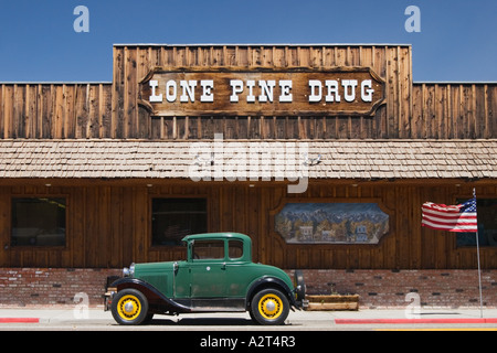 Antique Ford 'Model A' coupe and American flag in front of Lone Pine Drug store, Lone Pine, Inyo County, California, USA Stock Photo