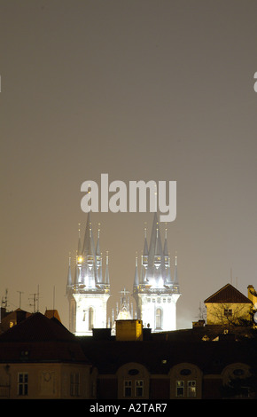 Spires of St John of Nepomuk Church, Old Town Square, Prague after dark illuminated over roof tops Stock Photo