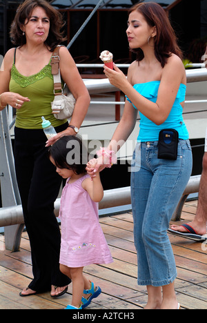 Young equatorian women eating ice cream in Guayaquil, Ecuador. Stock Photo