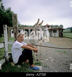 MAN AND DONKEY IN FRONT OF A HORSE STABLE BASQUE COUNTRY FRANCE EUROPE Stock Photo