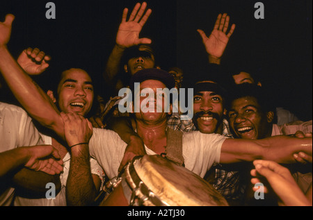 Crowd of male musicians in the street at night in the Santiago Carnival in Havana, Cuba Stock Photo