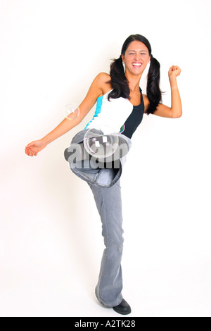 F.S. of young woman kicking some soap bubbles Stock Photo