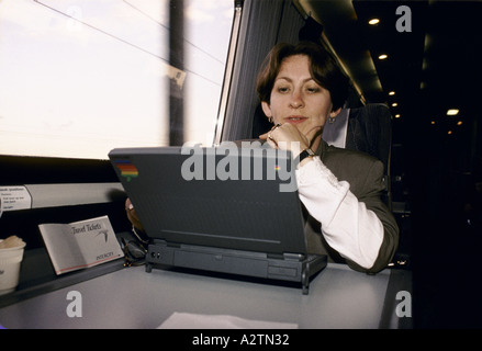 woman using laptop on train 1992 Stock Photo