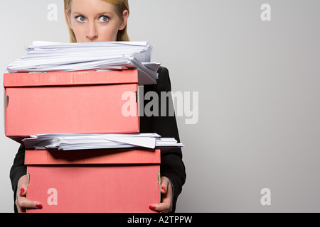 Woman holding stack of paperwork Stock Photo