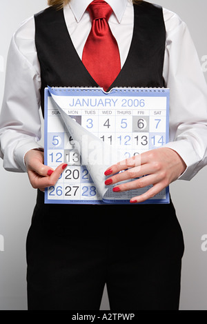 Businesswoman holding calendar Stock Photo