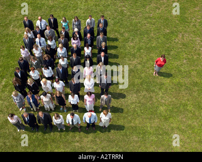 Woman separated from crowd Stock Photo