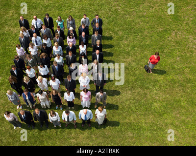 Woman separated from crowd Stock Photo