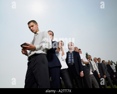 Businesspeople waiting in a queue Stock Photo