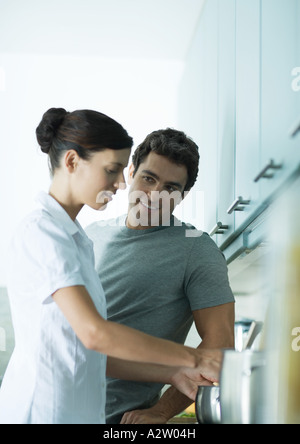 Couple cooking in kitchen together Stock Photo
