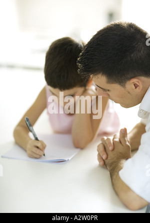 Father helping child with homework Stock Photo