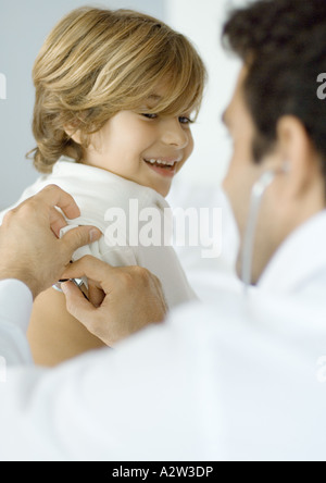 Man examining boy with stethoscope Stock Photo
